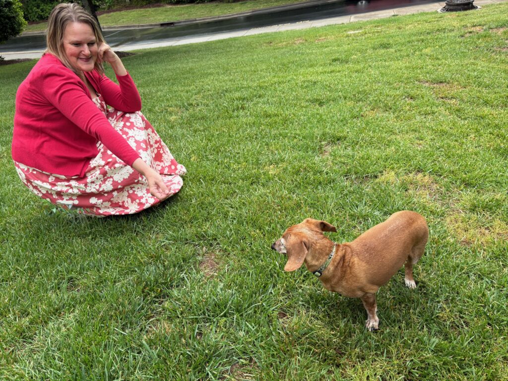 Photo of Karen Chiriboga playing with her dog Toby